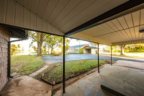 a view of a porch with furniture and garden