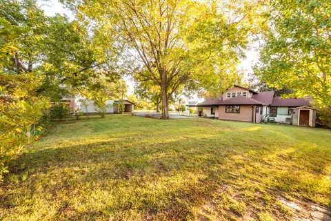 a front view of a house with a big yard
