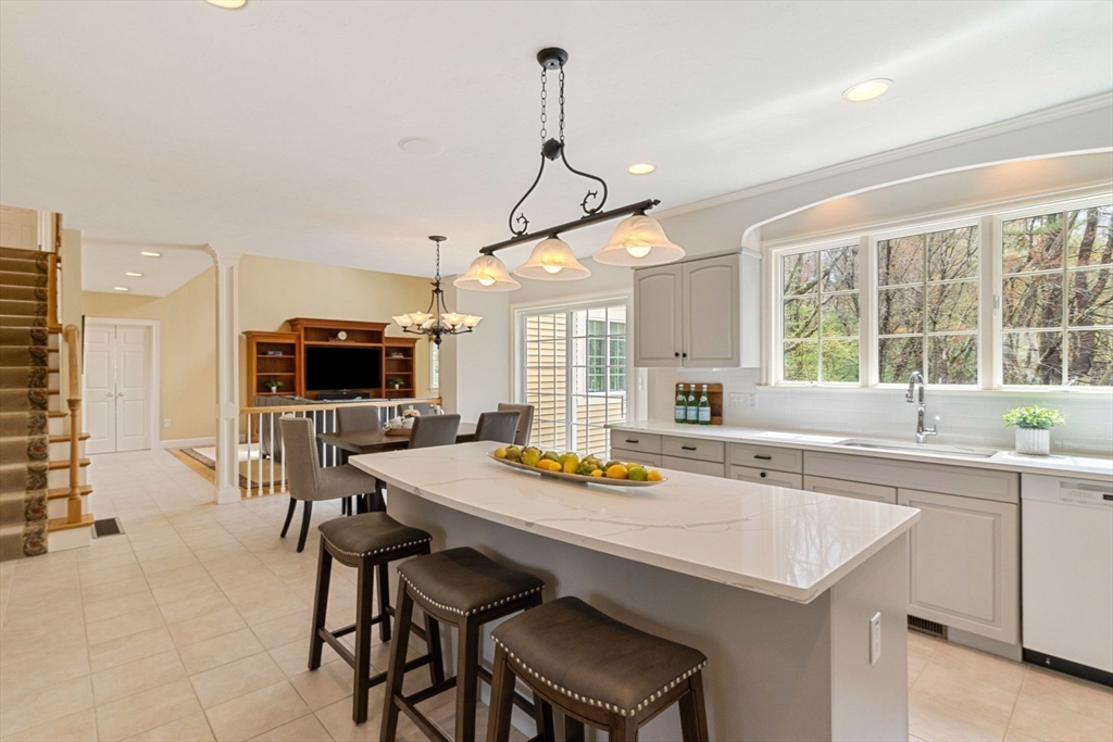 19 Buttonwood Drive Andover, MA 01810 - Photo 3 of 42 a kitchen with a sink a counter and chairs