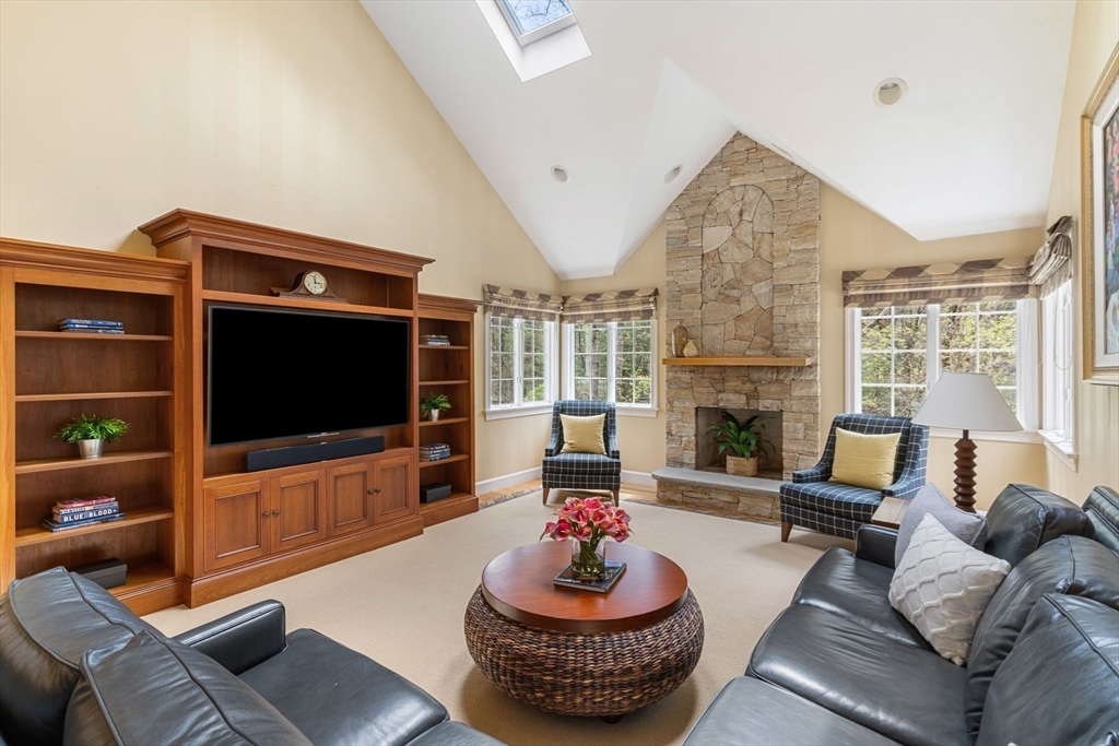 19 Buttonwood Drive Andover, MA 01810 - Photo 7 of 42 a living room with furniture a flat screen tv and a fireplace