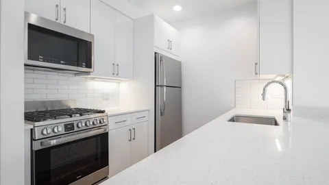 a kitchen with stainless steel appliances a stove a microwave and a refrigerator