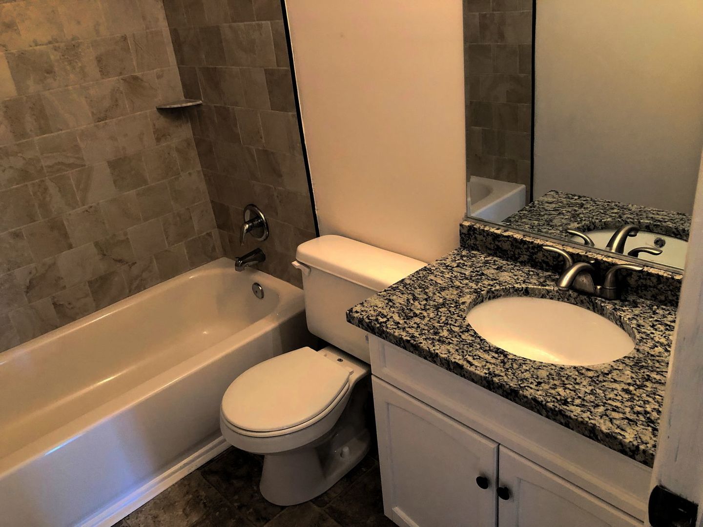 110 McKool Avenue Romeoville, IL 60446 - Photo 8 of 17 a bathroom with a granite countertop toilet a sink and bathtub