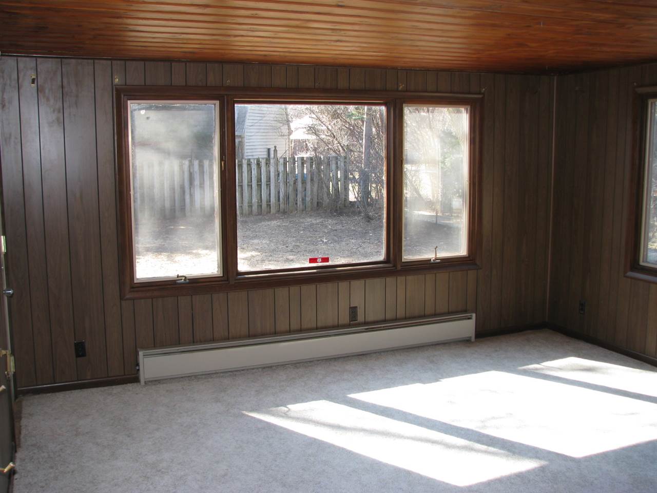 4009 Pinecrest Road Rockford, IL 61107 - Photo 7 of 20 an empty room with wooden floor and windows