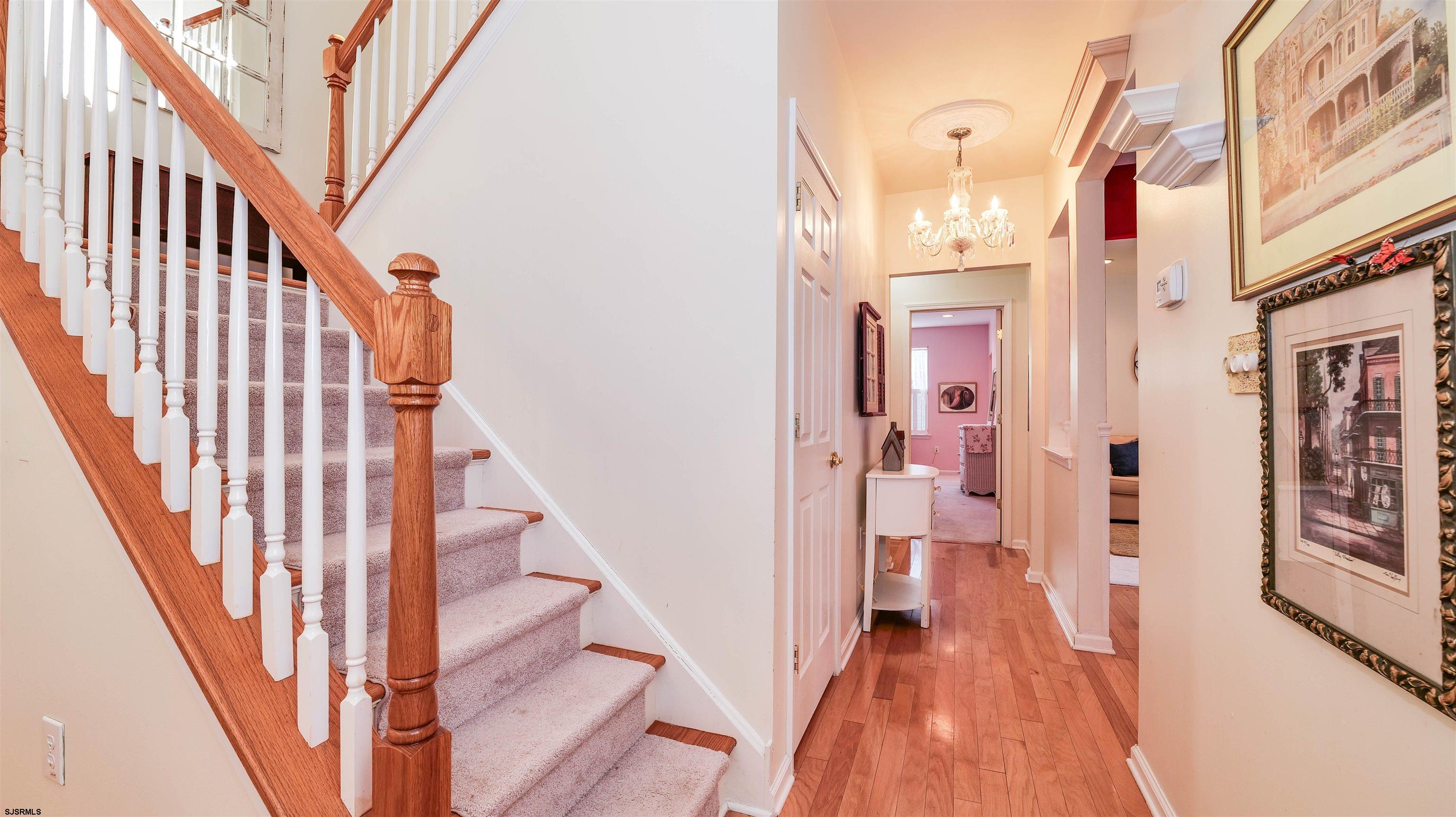 42 Ables Run Drive Absecon, NJ 08201 - Photo 11 of 43 a view of a hallway with wooden floor and staircase