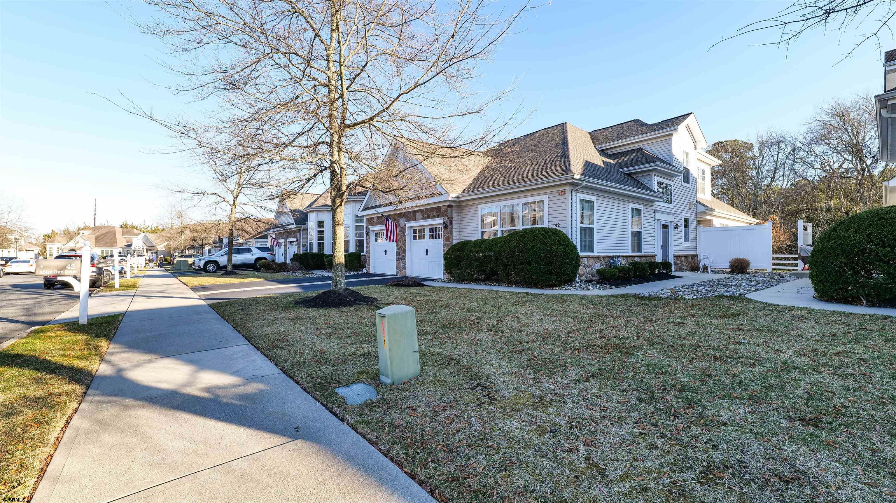 42 Ables Run Drive Absecon, NJ 08201 - Photo 2 of 43 a view of a white house next to a yard with big trees