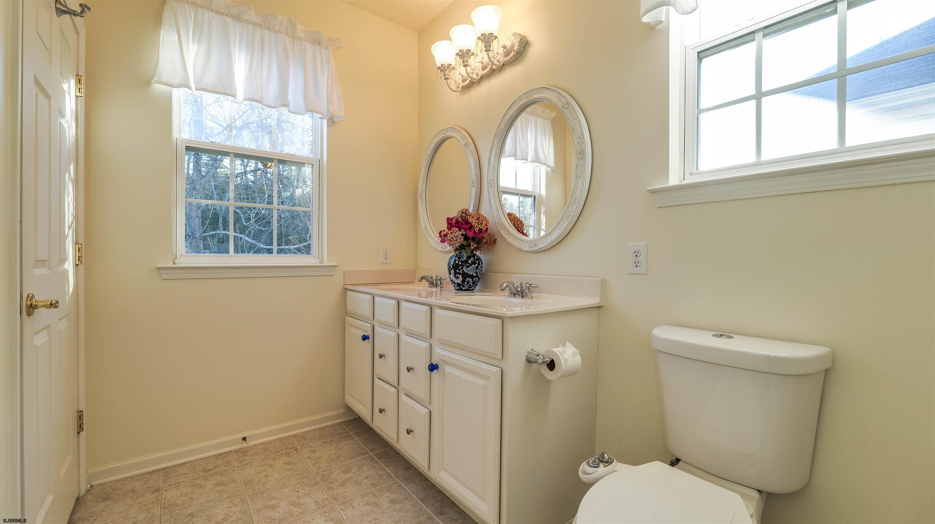42 Ables Run Drive Absecon, NJ 08201 - Photo 22 of 43 a bathroom with a sink a toilet and a mirror