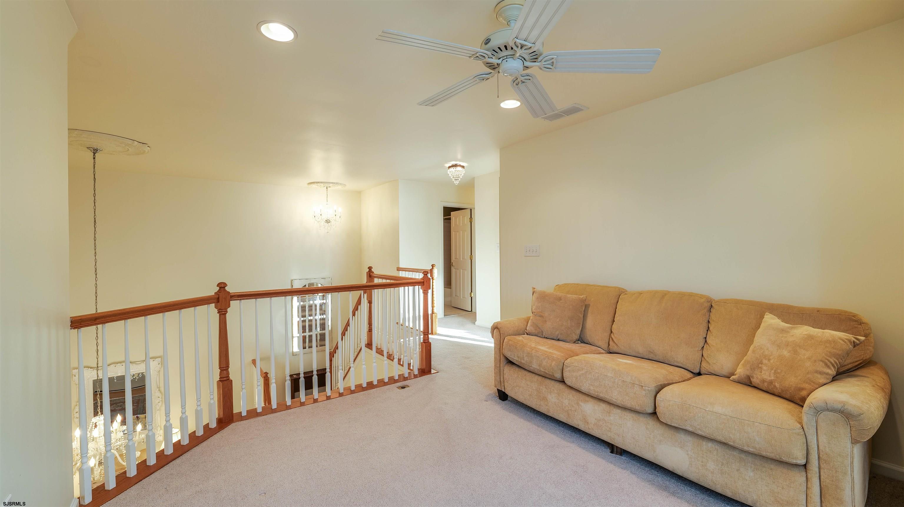 42 Ables Run Drive Absecon, NJ 08201 - Photo 29 of 43 a living room with furniture and a chandelier