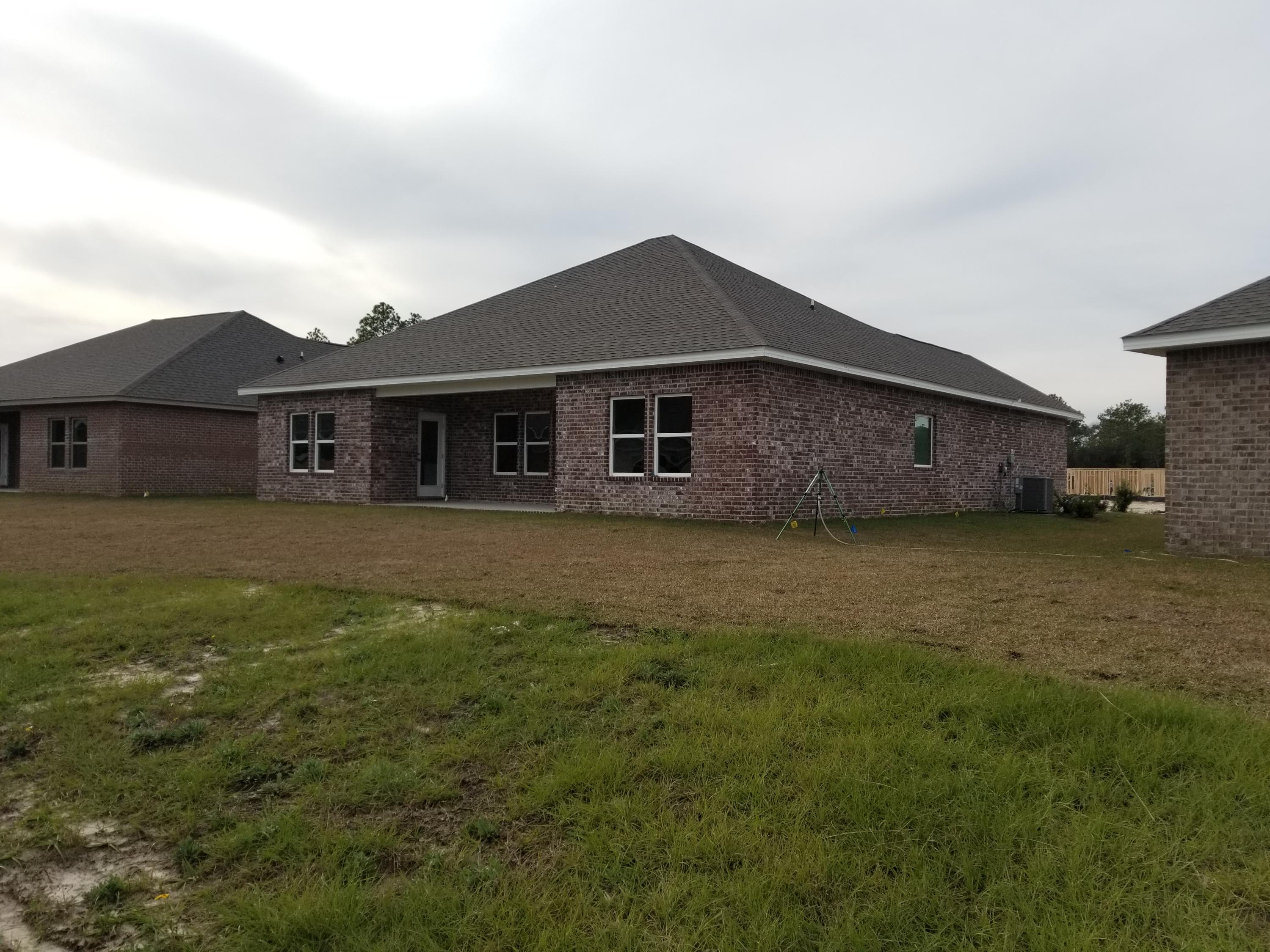 263 Conner Circle Santa Rosa Beach, FL 32459 - Photo 29 of 44 a front view of a house with a yard