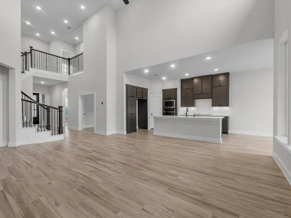 a view of kitchen with kitchen island a sink stainless steel appliances and cabinets
