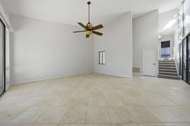 a view of a room with a ceiling fan and a ceiling fan