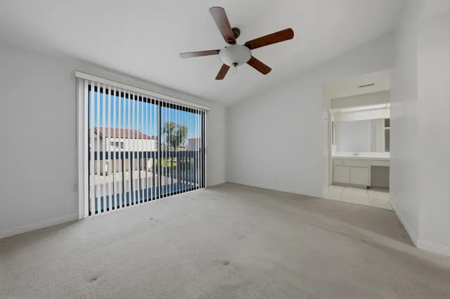 a view of a livingroom with a ceiling fan and window