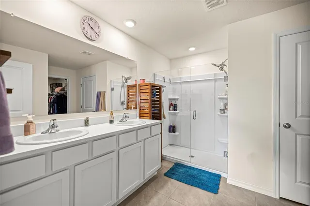 a bathroom with a double vanity sink mirror and double