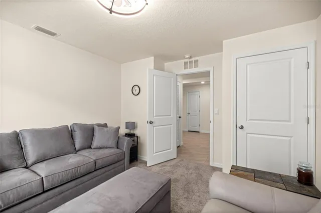 a living room with furniture and white walls