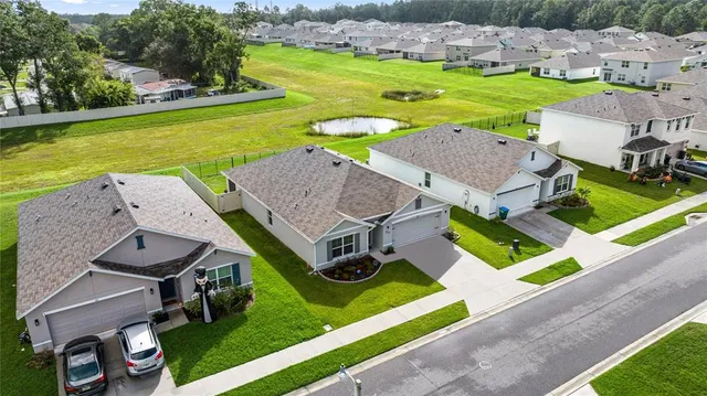 an aerial view of a house with swimming pool and outdoor space