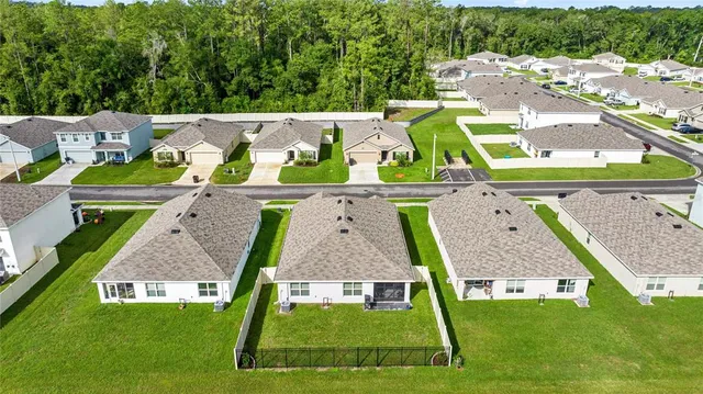 an aerial view of a house with swimming pool garden and patio