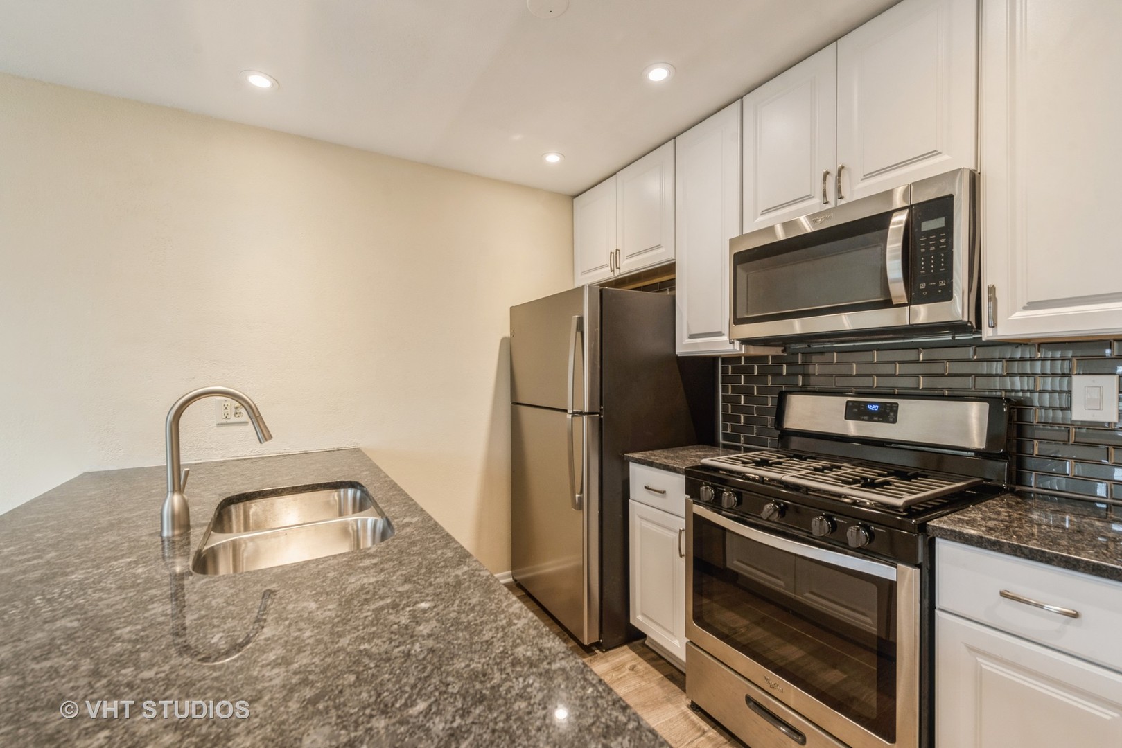 30 Hickory Lane Cary, IL 60013 - Photo 5 of 16 a kitchen with granite countertop a sink stainless steel appliances and cabinets