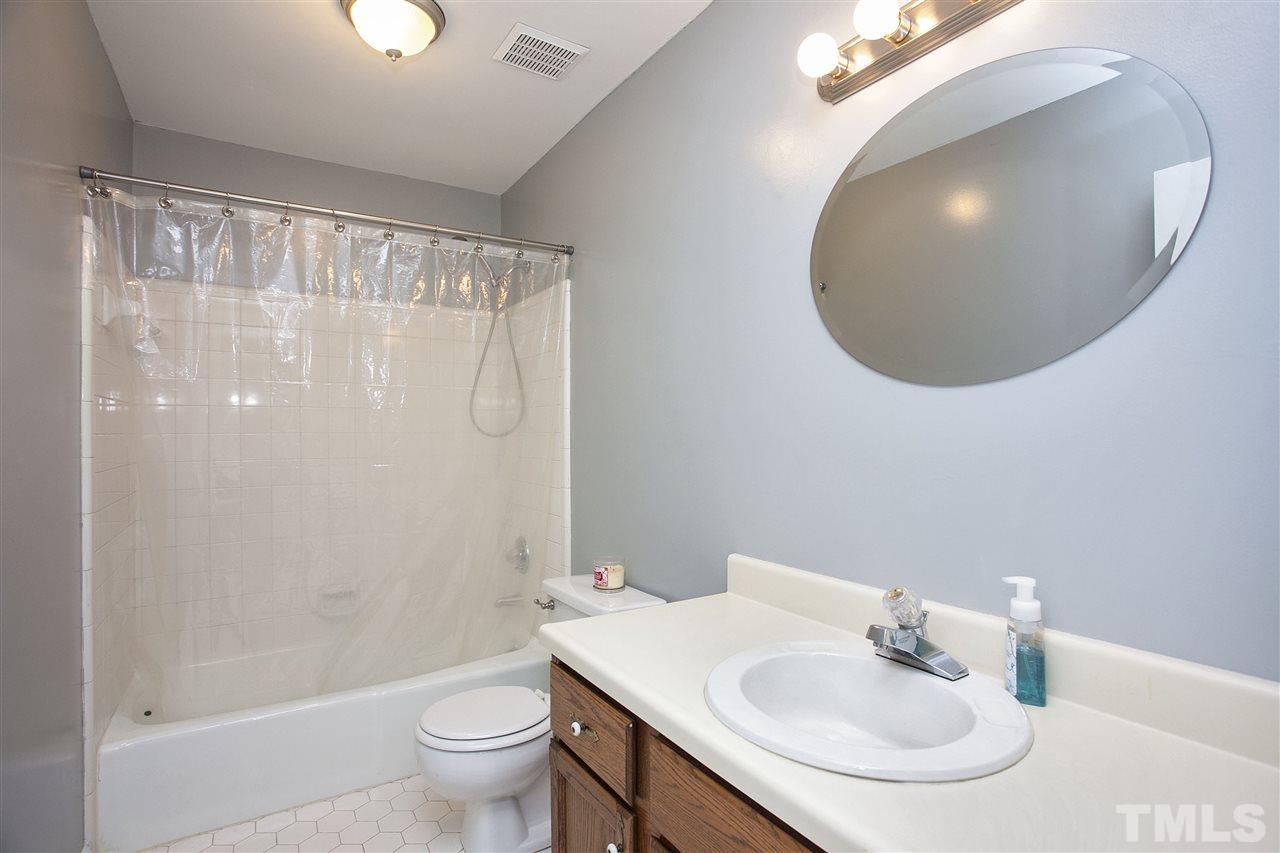 1500 Ferncliff Circle Raleigh, NC 27609 - Photo 13 of 25 a bathroom with a sink and a mirror
