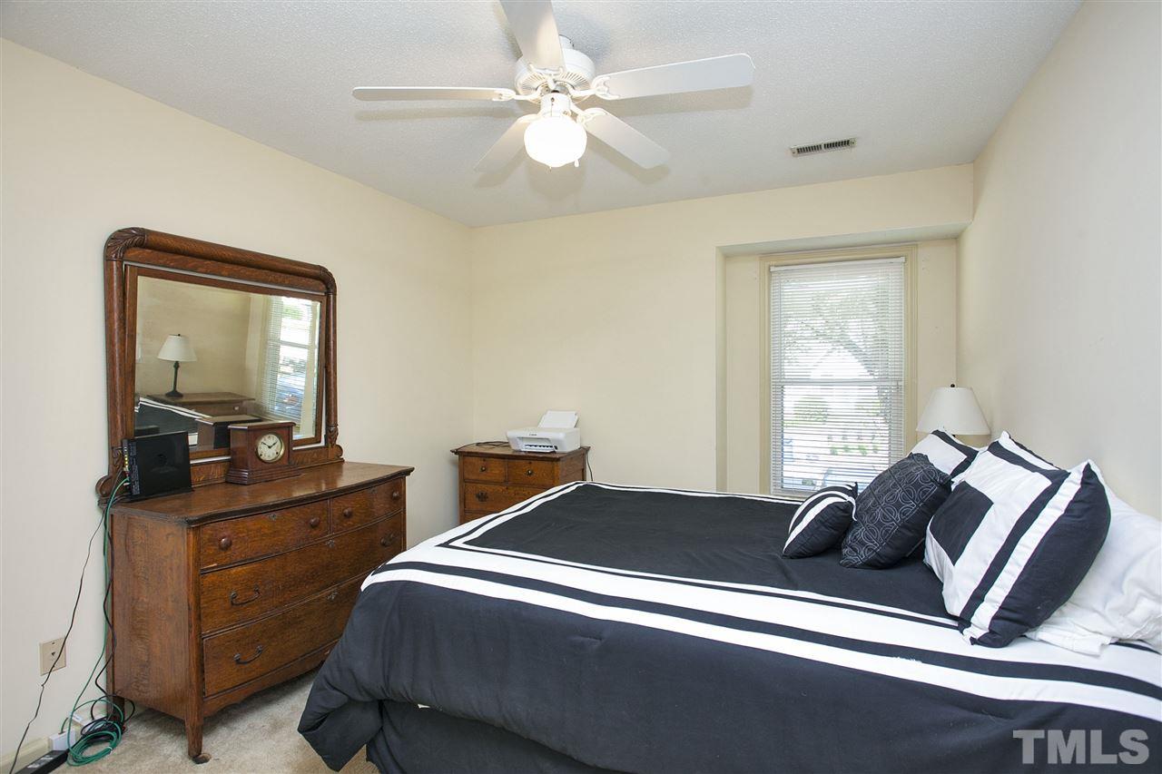 1500 Ferncliff Circle Raleigh, NC 27609 - Photo 14 of 25 a bedroom with a bed and a dresser