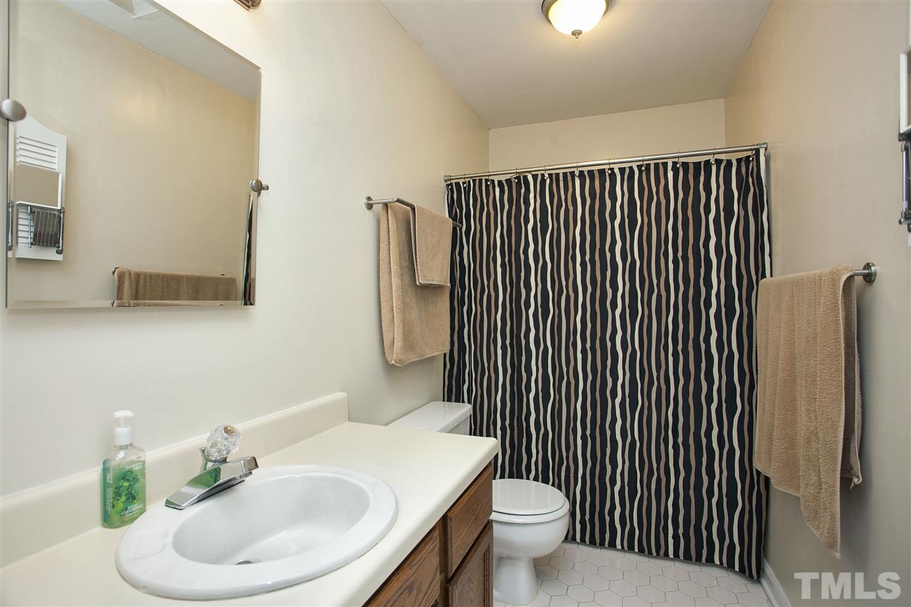 1500 Ferncliff Circle Raleigh, NC 27609 - Photo 16 of 25 a bathroom with a sink a toilet and mirror