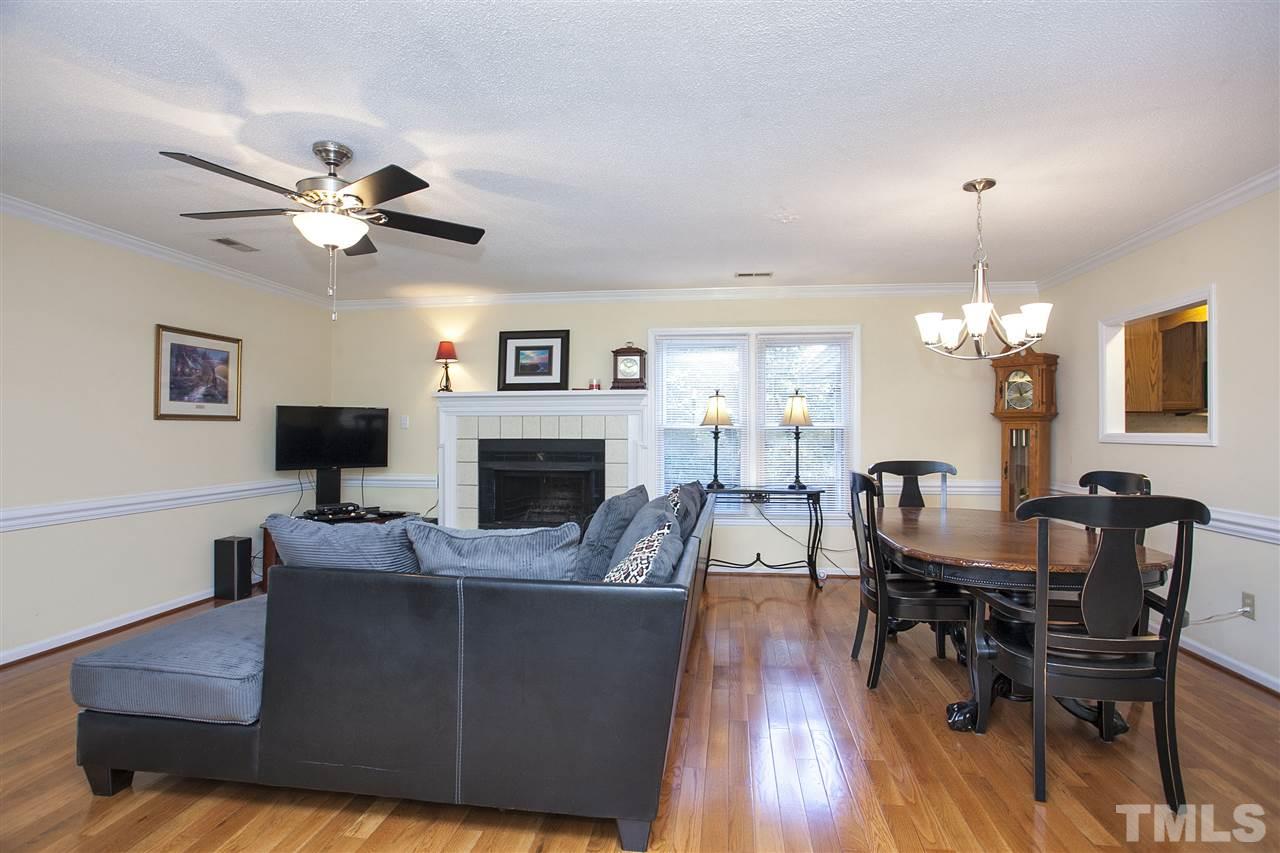 1500 Ferncliff Circle Raleigh, NC 27609 - Photo 6 of 25 a living room with furniture a fireplace and a flat screen tv
