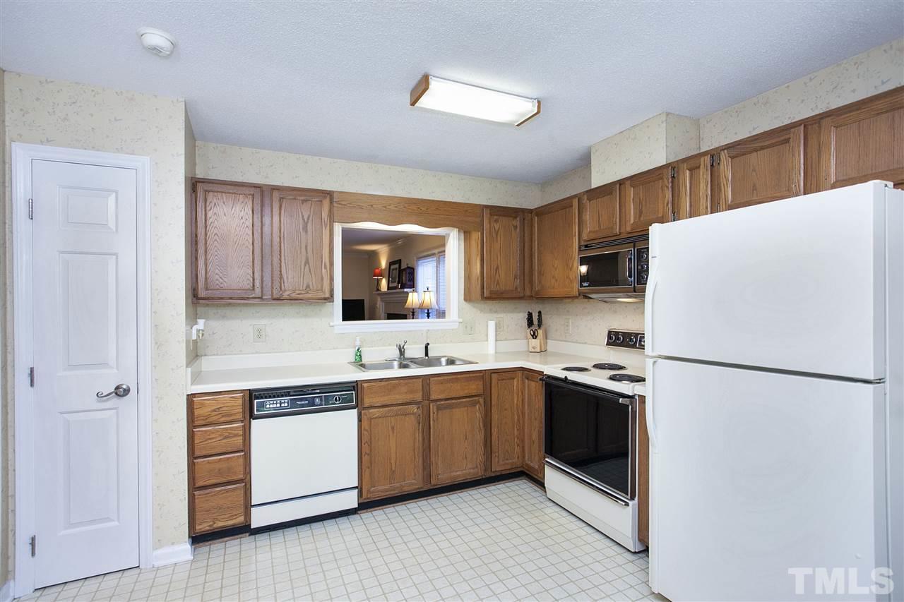 1500 Ferncliff Circle Raleigh, NC 27609 - Photo 9 of 25 a kitchen with a sink a refrigerator and cabinets