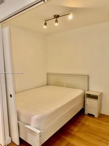 a bed sitting in a bathroom next to a shower