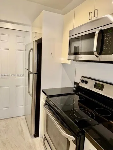 a kitchen with a stove microwave and refrigerator