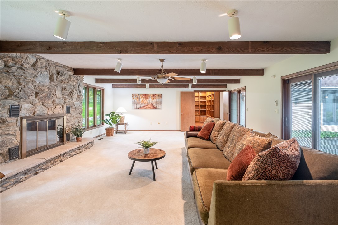 273 North Alpha Bellbrook Road Dayton, OH 45434 - Photo 8 of 43 This inviting living room features a stone fireplace, exposed beams, and ample natural light.