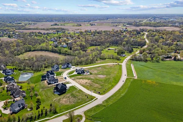 aerial view of a house with a garden and lake view