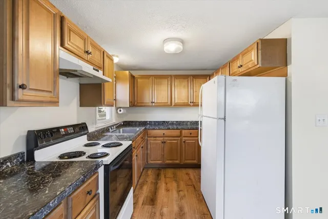 a kitchen with a stove a sink and a refrigerator