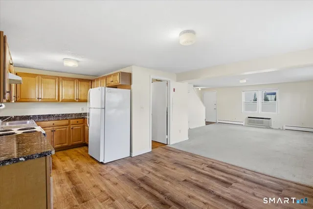 a view of a kitchen with a sink refrigerator and cabinets