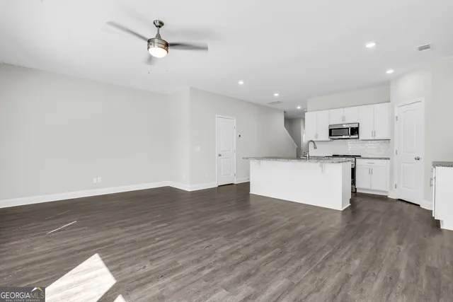 a view of a kitchen with a sink and a stove top oven