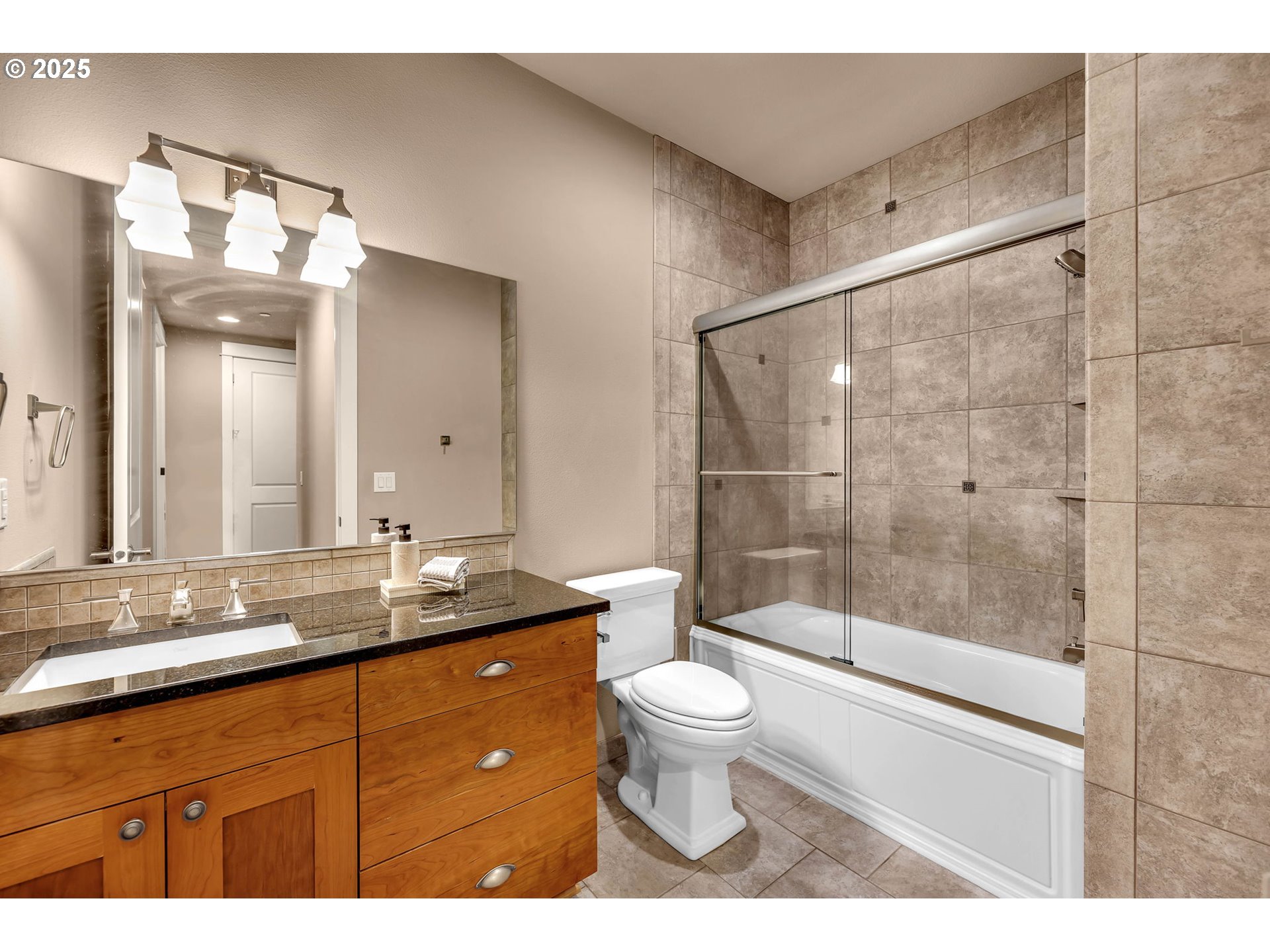 4029 Northwest 77th Avenue Camas, WA 98607 - Photo 26 of 33 a bathroom with a granite countertop sink a toilet a mirror and shower