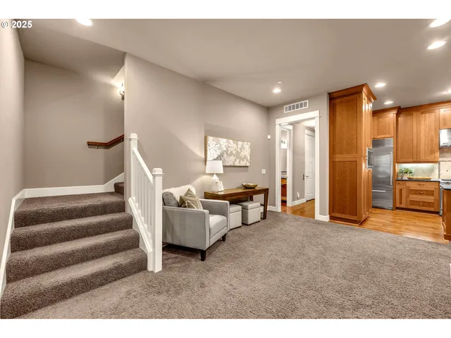 a living room with furniture and a kitchen