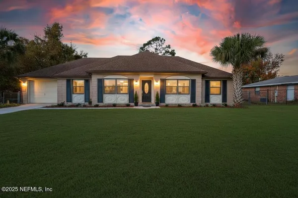 a front view of a house with a garden