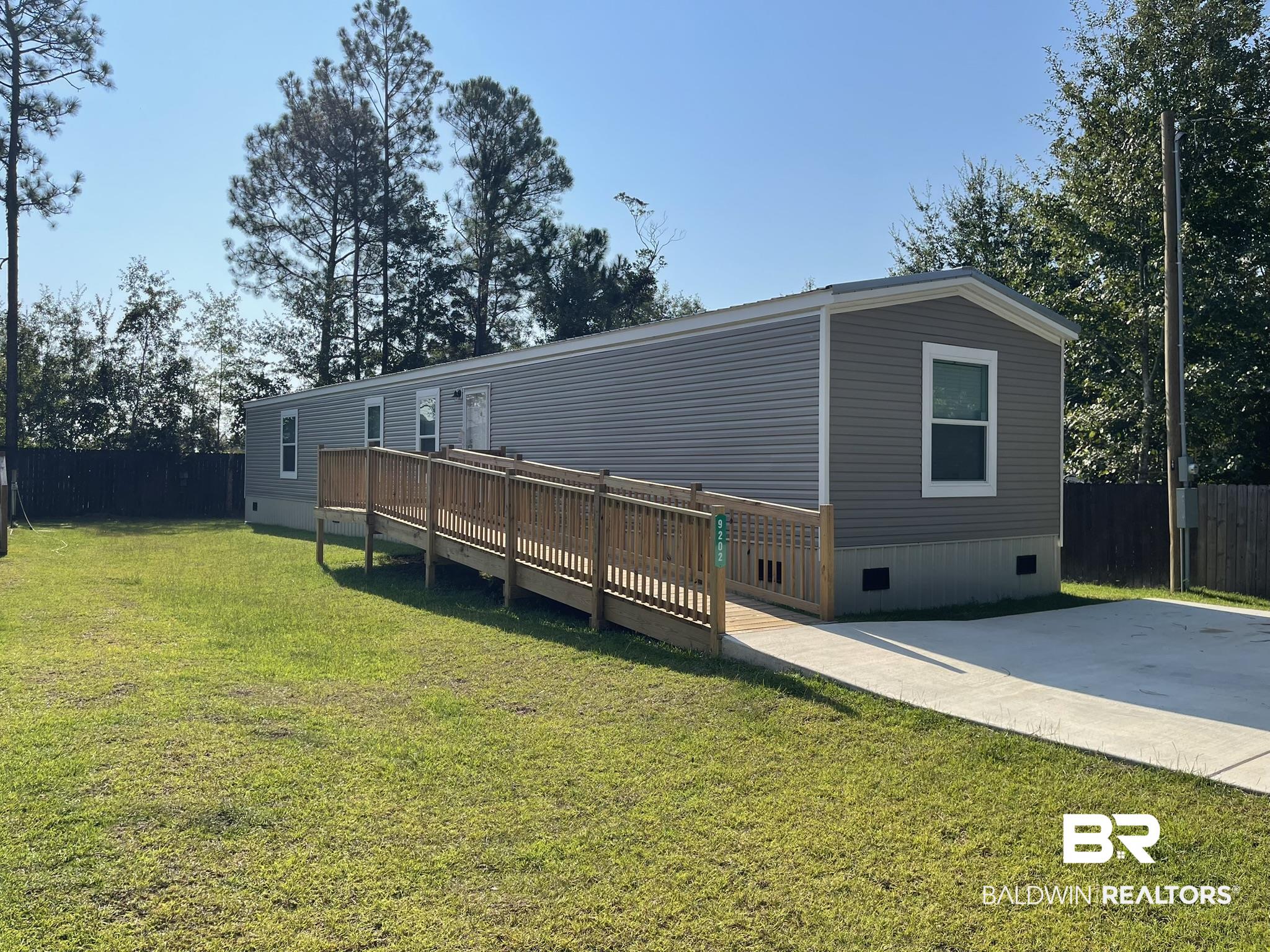 9202 Bay Pnes Road Elberta, AL 36530 - Photo 1 of 17 Rear view of property featuring crawl space and a wooden deck