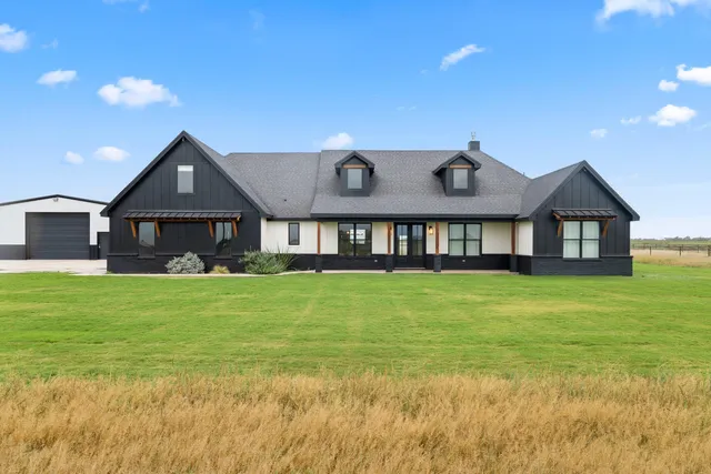 a front view of a house with a yard and balcony