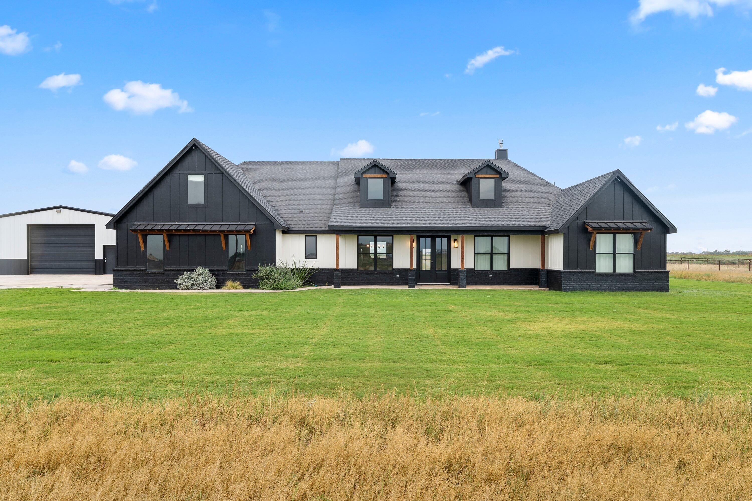 a front view of a house with a yard and balcony