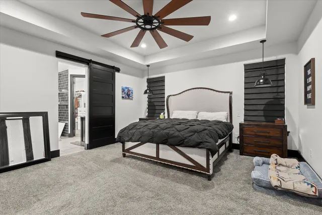 a bedroom with a bed mirror and window