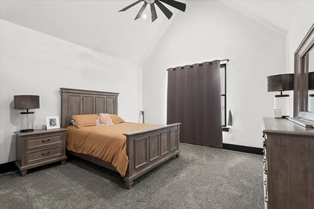 a bedroom with a bed and a flat tv screen on the dresser