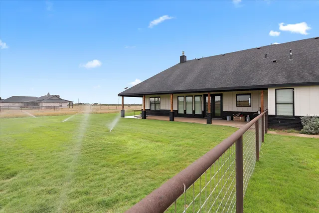a view of a house with pool and a yard