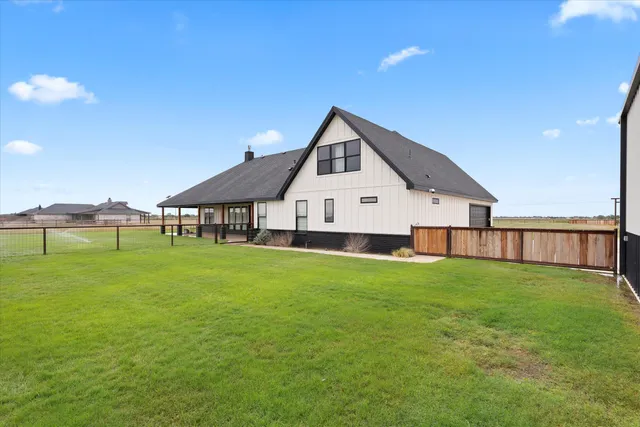 a view of a house with a yard and porch