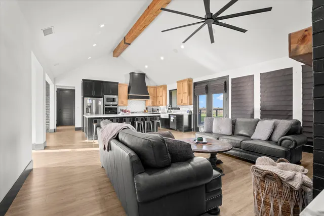 a living room with furniture and a view of kitchen