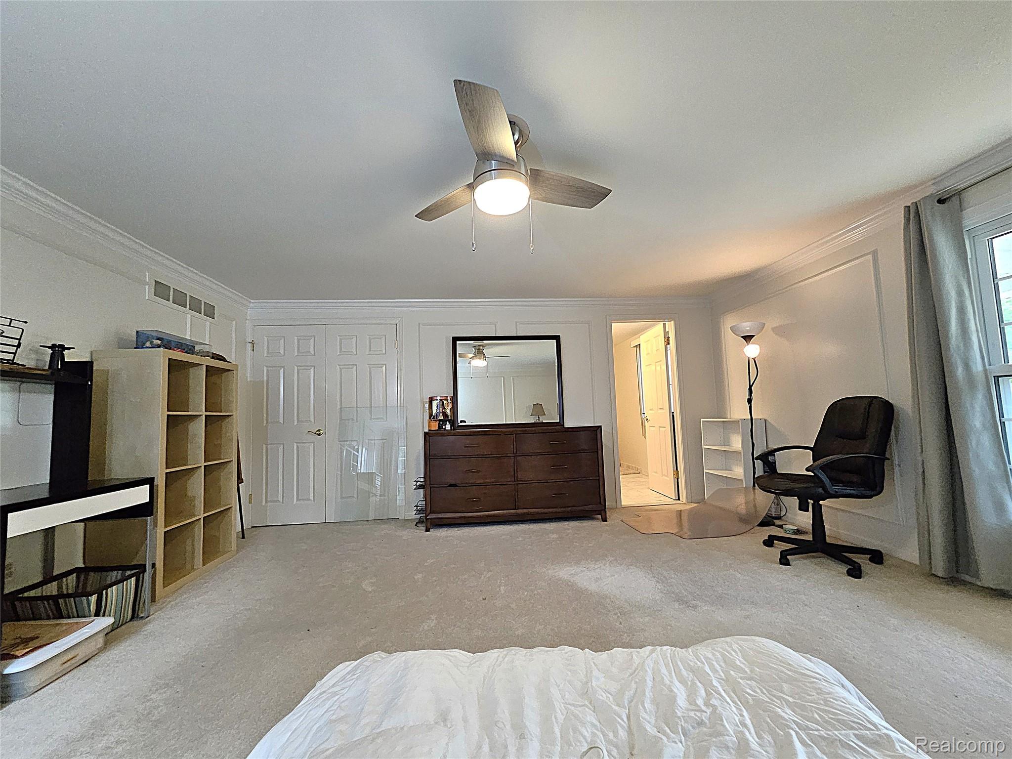 1114 Chaffer Drive Rochester, MI 48306 - Photo 35 of 50 Carpeted room featuring a ceiling fan with integrated lighting, crown molding, paneled walls, and a window with drapes