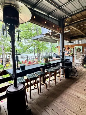 a view of a chairs and table in patio with a fireplace