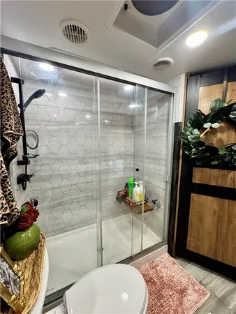 a bathroom with a granite countertop bathtub a sink and a shower