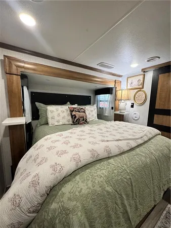 a bedroom with a bed and mirror