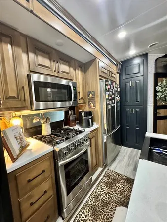 a kitchen with a stove and a refrigerator