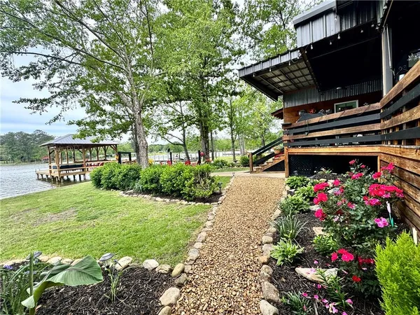 a front view of a house with a yard and a garden
