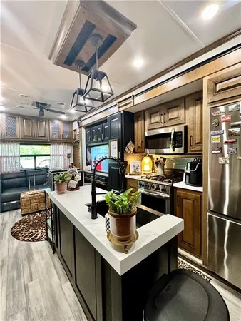 a kitchen with stainless steel appliances granite countertop a sink a stove and a refrigerator